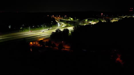 midnight traffic a4 highway in katowice city - illuminated intersection - drone view 4k