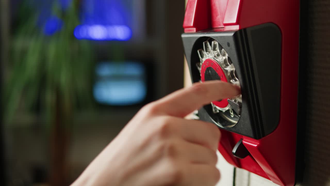 Retro vintage phone, red rotary telephone is displayed on a wooden desk, adding a nostalgic touch