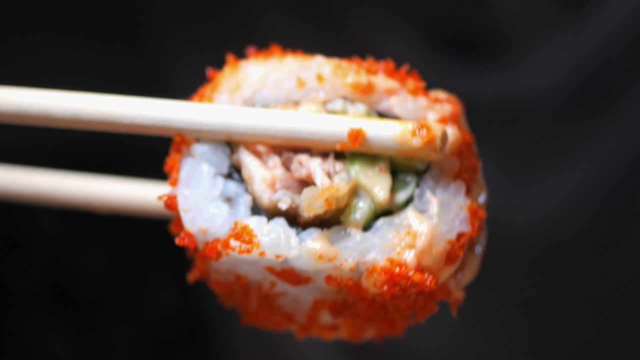 Sushi roll with chopsticks