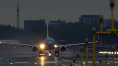 airplane landing in the rain at night