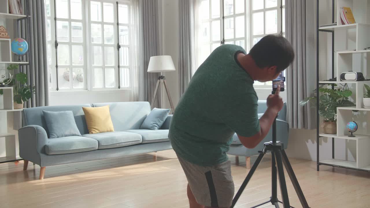 Asian Man Blogger Shoots Video Content For Social Networks By Smartphone Camera, Magician With Red Ball