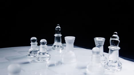 a chess match: a rook eating a king on a chessboard made of glass material