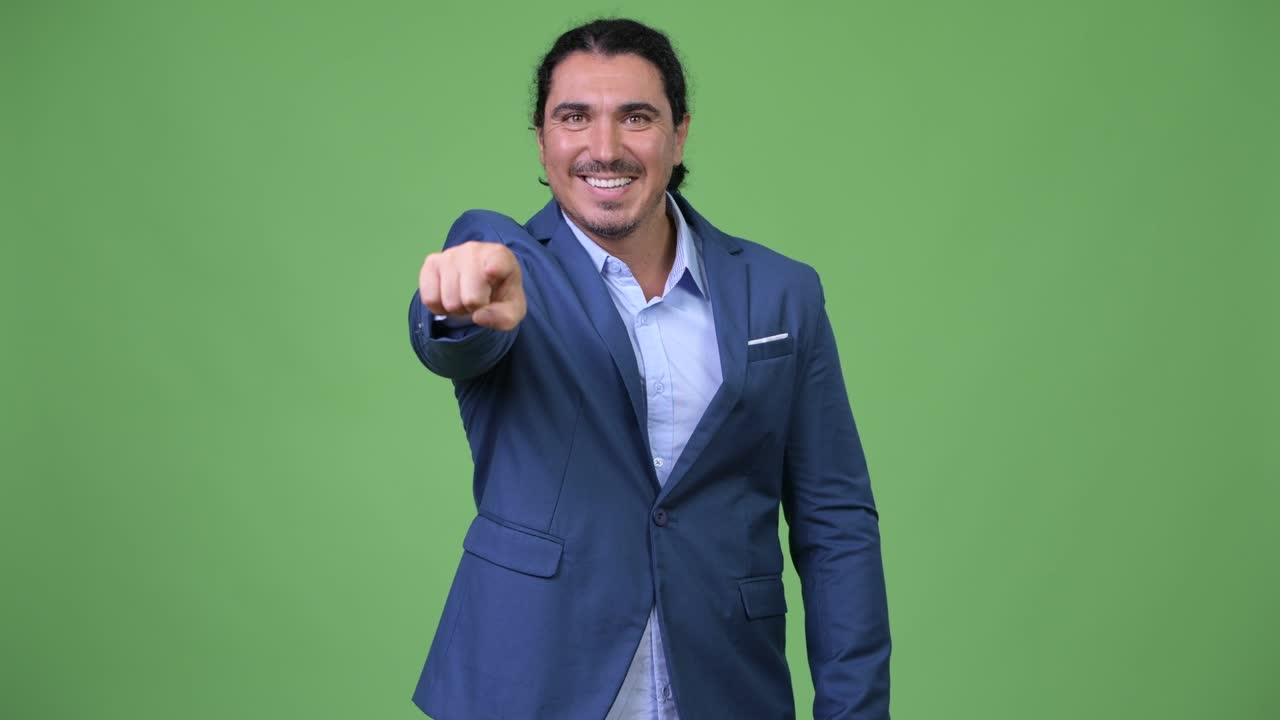Handsome businessman pointing to camera