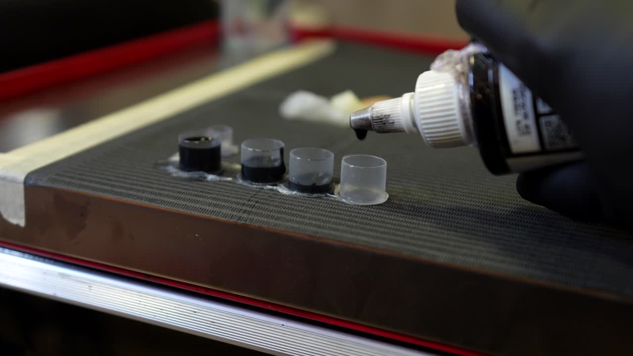 Tattoo Artist Preparing Ink for Tattoo Session
