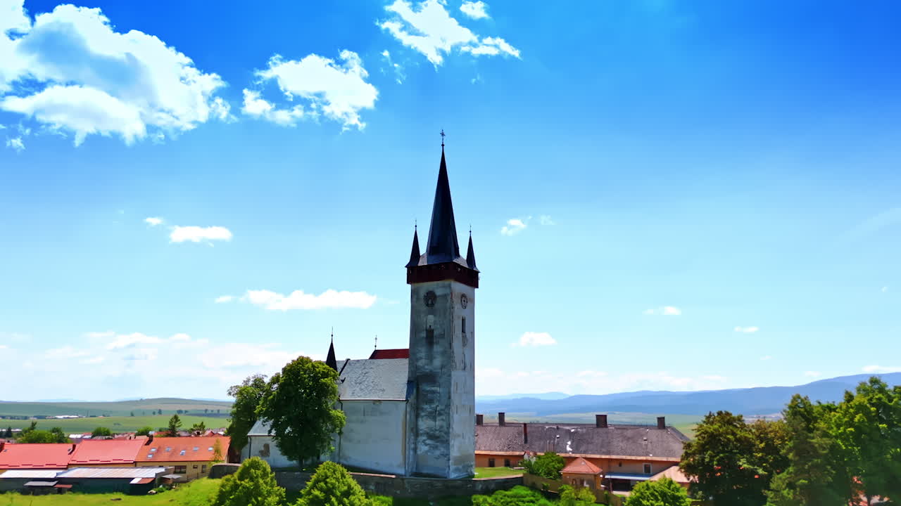 Flying closer to the old church in the rural area. Beautiful nature surrounds the building. Bratislava, Slovakia.
