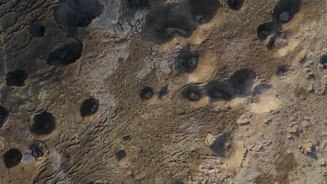 aerial top down shot, from close to long shot of many sinkholes in the dead-sea desert, israel