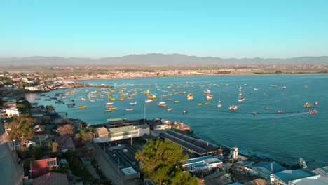 panoramic aerial view of the shore of the tongoy peninsula with fishing boats stopped at sunset, chile