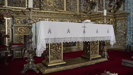 ornate church altar with intricate decor and white lace draped cloth