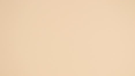 creative tropic gold and green palm leaves appear in two ways on nude background. stop motion