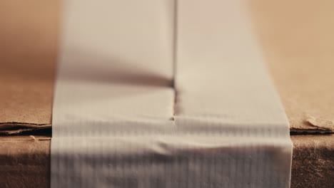 cutting tape on a cardboard box