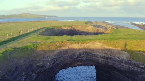 sunrise casts a full-body shadow walking across the bridges of ross arch, evoking mystery and a sense of wonder