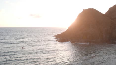 tourist kayaking near mokulua island on a sunny morning in oahu, hawaii