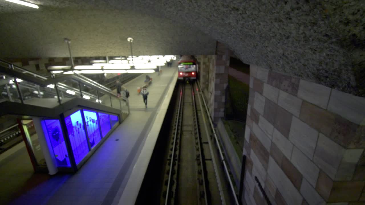 Train leaving the subway station, top shot from a bridge over the subway