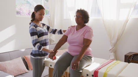 Senior-mixed-race-woman-exercising-at-home.-Social-distancing-and-self-isolation-in-quarantine