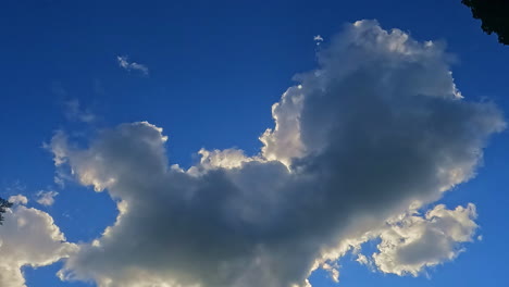 Big-cloud-covered-by-the-sun-as-seen-from-the-earth,-human-perspective-of-the-Sky,-blue-skyline