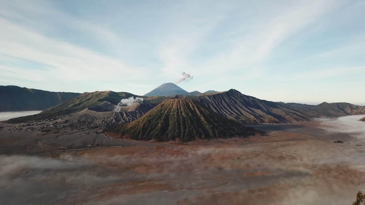 Beautiful view of Mount Bromo National Park in the morning with thin mist covering the area.