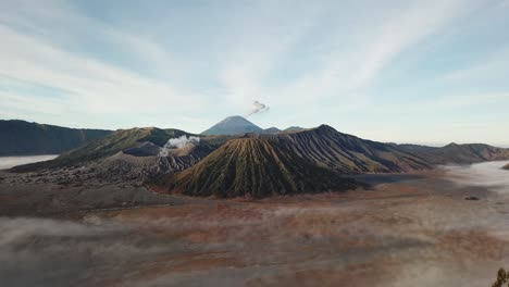 beautiful view of mount bromo national park in the morning with thin mist covering the area.