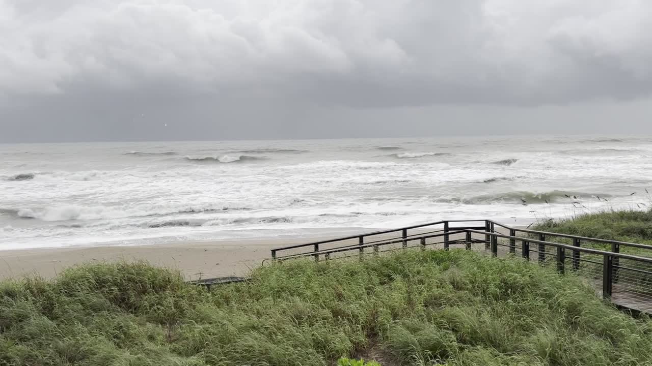 Dramatic footage of Hurricane Miguel in Jensen Beach, Florida. Powerful waves crash against the shore, showcasing extreme weather and storm surge. Perfect for documentaries, news, and disaster footage