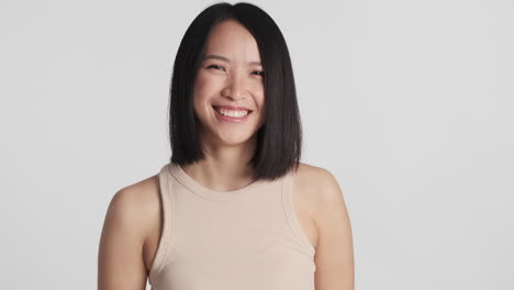 Asian-woman-nodding-and-smiling-on-camera.