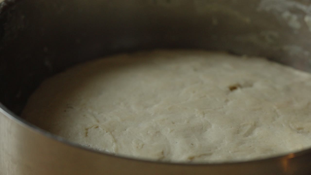 Rising dough under a towel. White flour with sourdough preparing for baking bread. Homemade traditional pastries in the Czech Republic