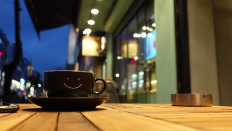 smiling coffee cup at nighttime cafe