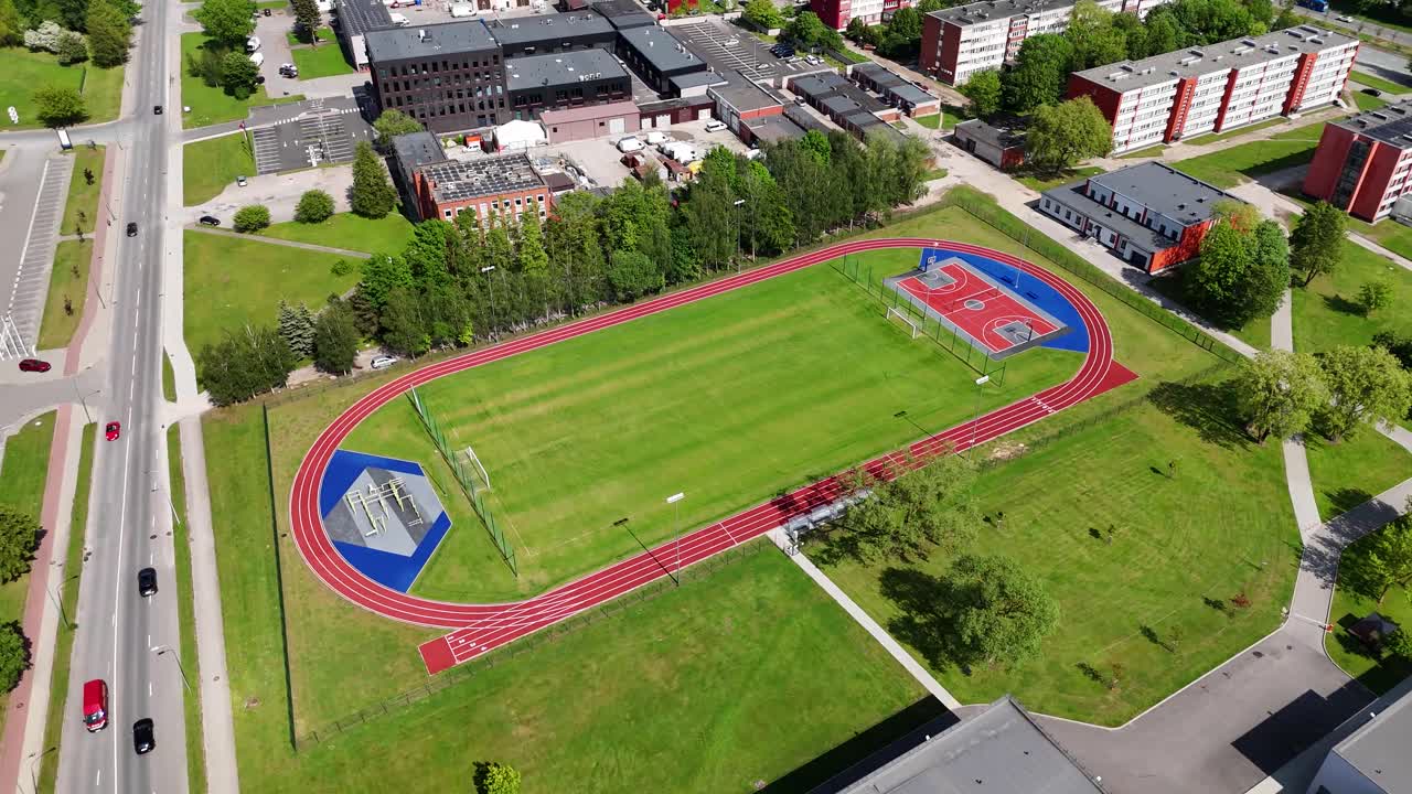 Aerial view of urban playground with track, sunny day, vibrant greenery