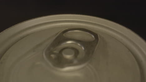 macro dolly out of top of metal soda can spinning