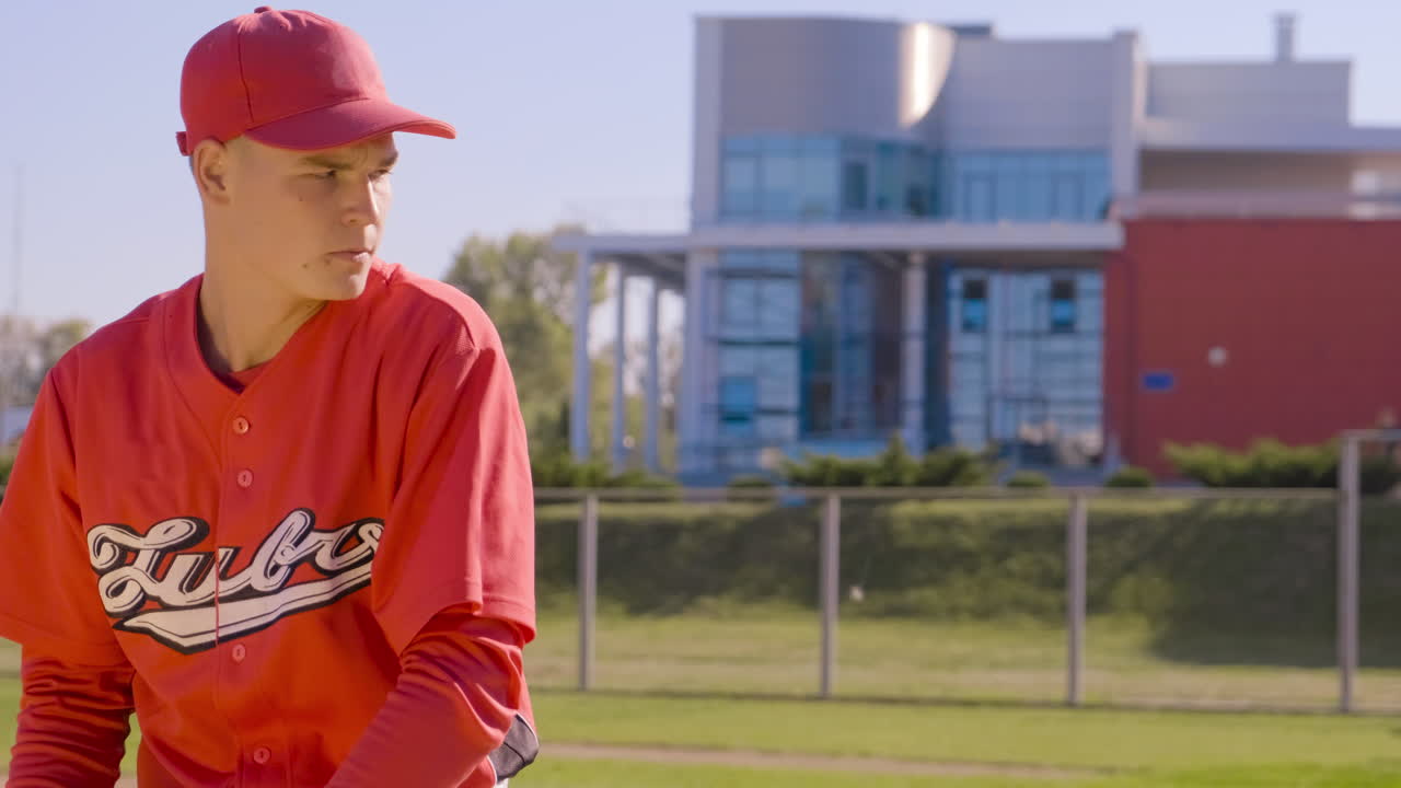 A young pitcher energetically practicing his baseball skills on a bright sunny field