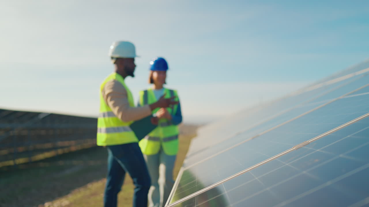 Engineers Inspecting Solar Panels at a Solar Farm
