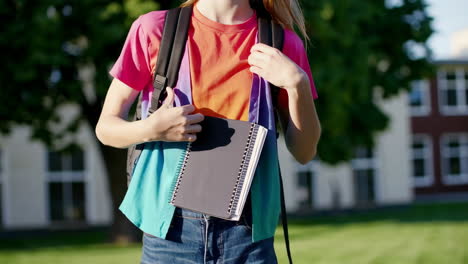 teenage girl with backpack and notebook