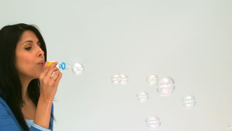 cute woman blowing bubbles