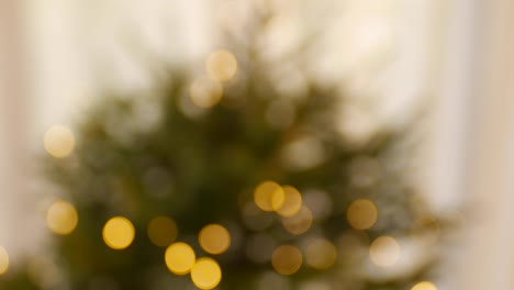 blurred background of christmas tree with golden bokeh.