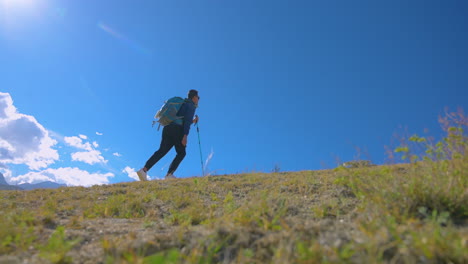 male tourist treks towards the upper hill of upper mustang nepal