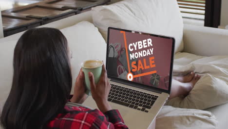 mujer biracial usando una computadora portátil en casa para comprar en línea, cámara lenta