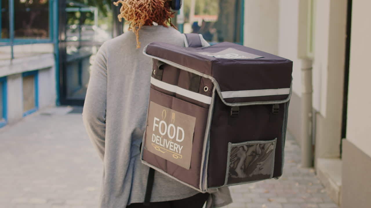 Food delivery person with backpack