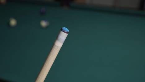 player chalking pool cue during billiards game