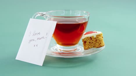 black tea with heart shape cookie and i love you mom text on card