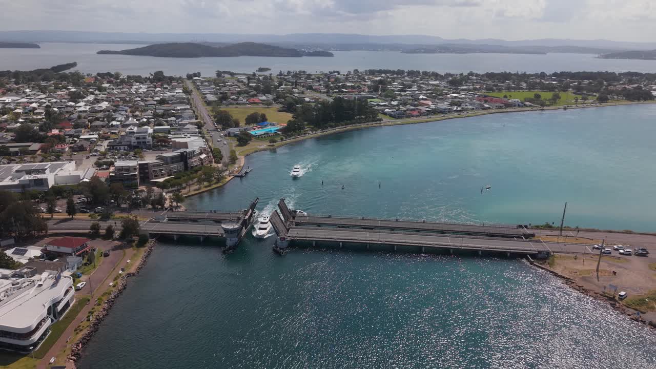 Aerial drone, Swansea drawbridge fully raised as vessel passes between at midday