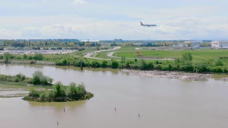 panoramic scenery of yvr- vancouver international airport with an arriving airplane in richmond, canada