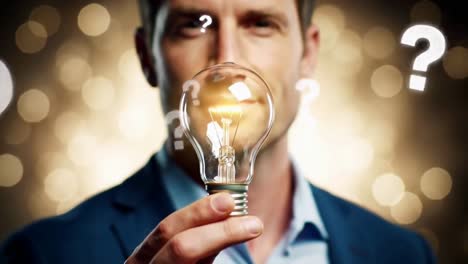 businessman finding a solution holding a lightbulb surrounded by question marks