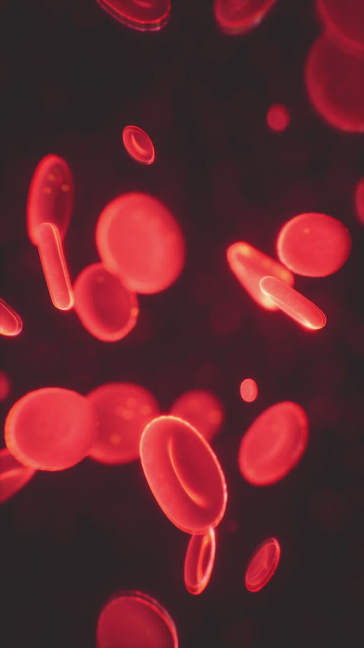 Red blood cells floating in a dark background