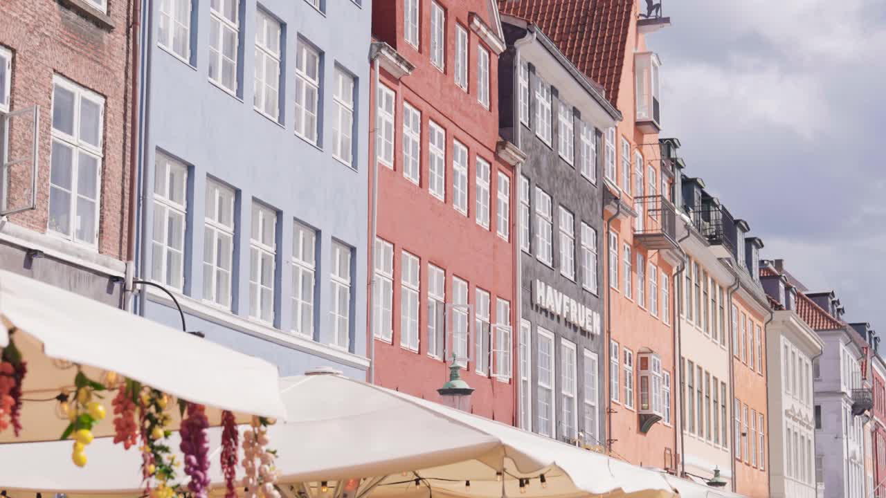 Colorful building exterior wall near Nyhavn waterfront canal, Copenhagen
