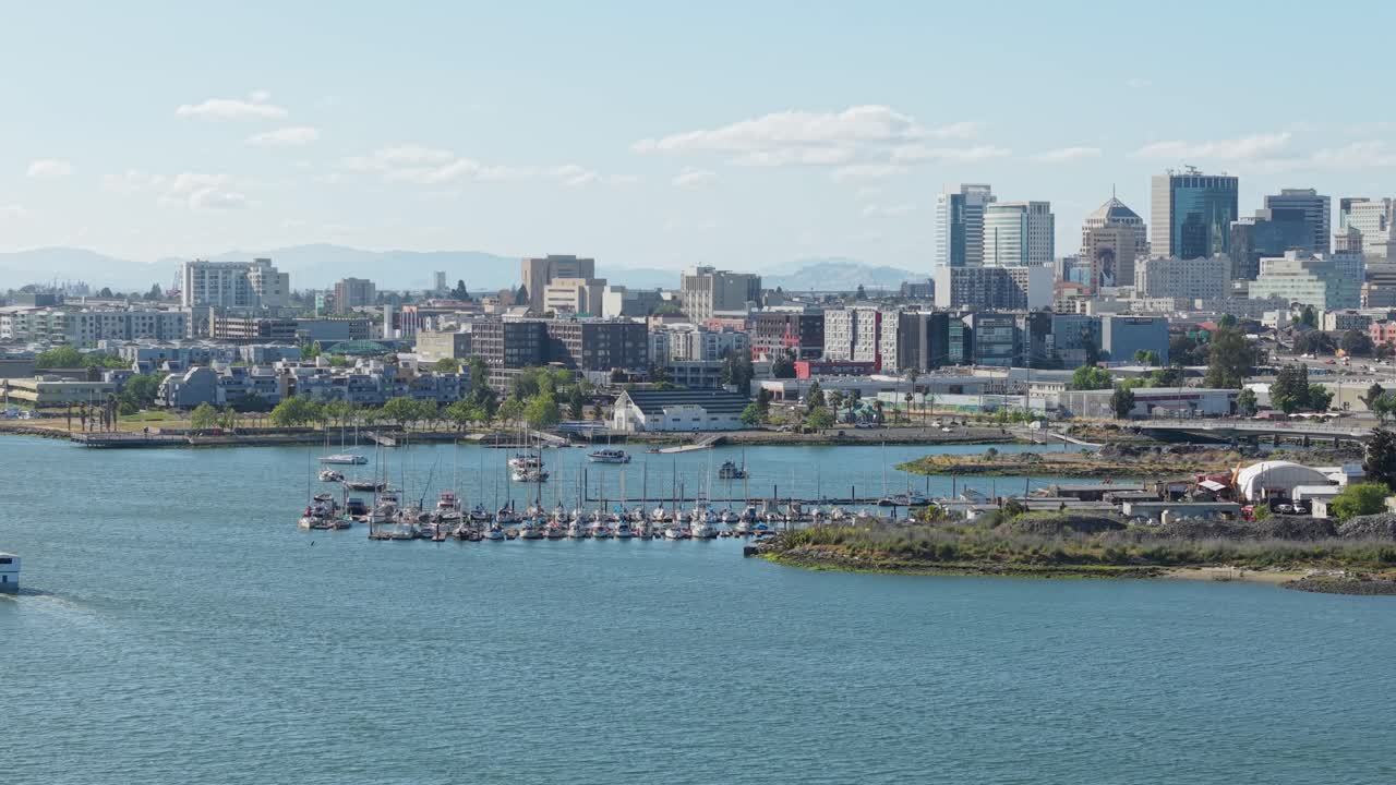 Aerial view captures the busy charm of Jack London Square, where boats line the docks and city life meets the bay.