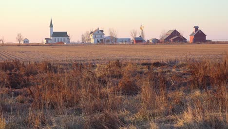 establishing shot of a classic beautiful small town farmhouse farm and barns in rural midwest america york nebraska 1