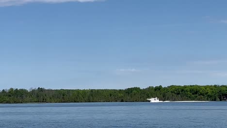 white speedboat in the blue sea in summer - pov