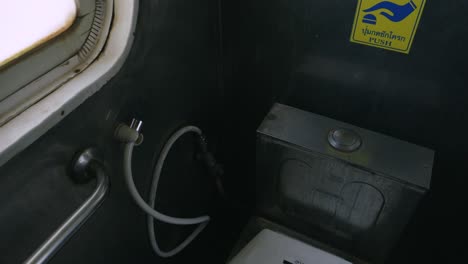 handheld shot of train toilet in a thailand's eastern line train from bangkok to ban klong luk during the day in thailand
