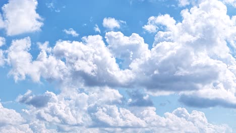 white fluffy clouds forming and swimming across endless sky, time lapse view