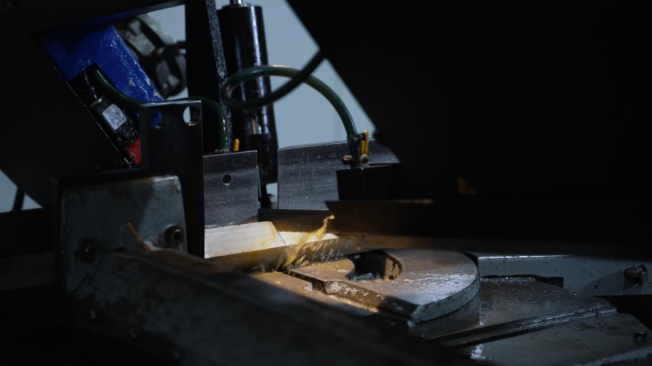 Rapidly rotating saw blade of the machine cuts the metal iron beam. Water jet cooling against heating. Automatic production