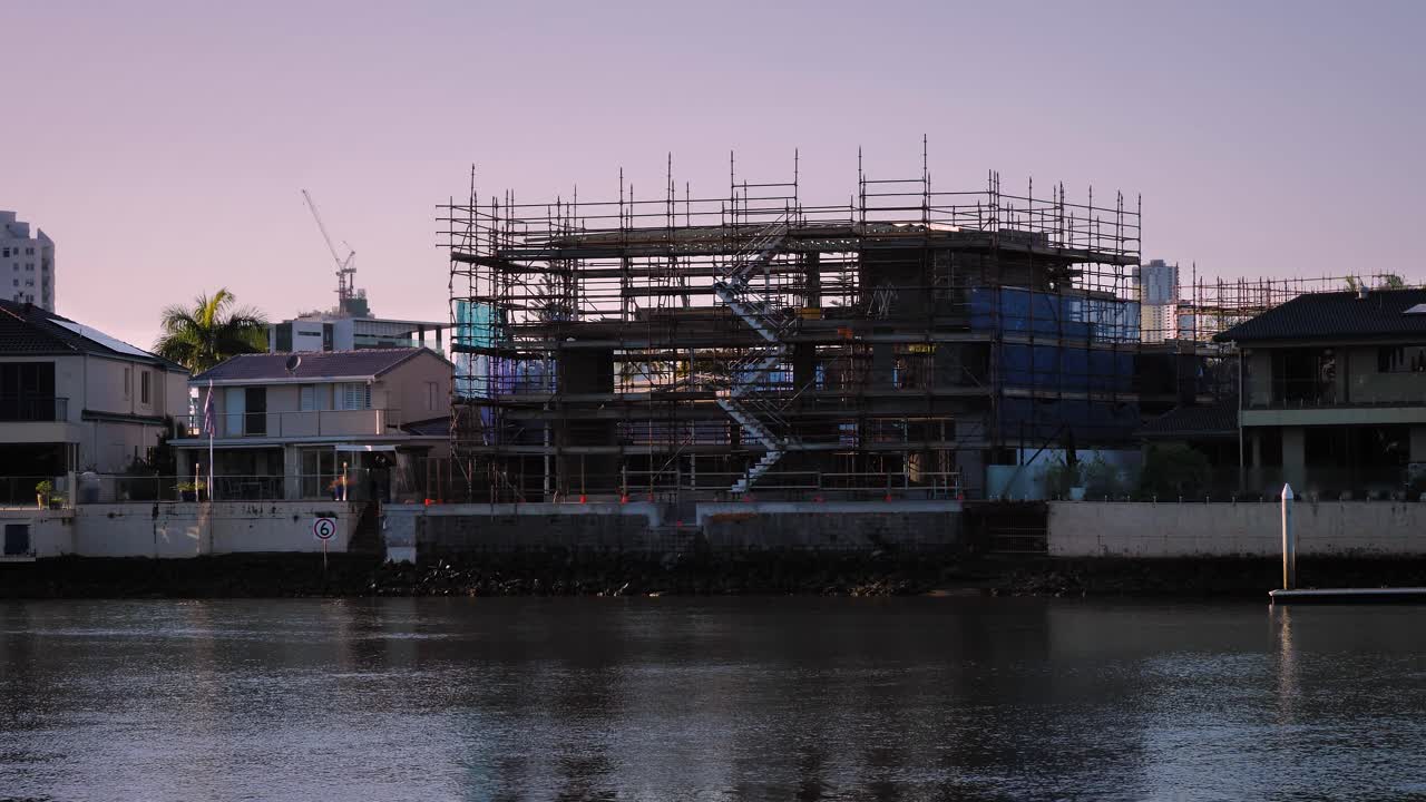 House build along the Nerang River at sunrise on a sunny day, Surfers Paradise, Gold Coast, Queensland, Australia