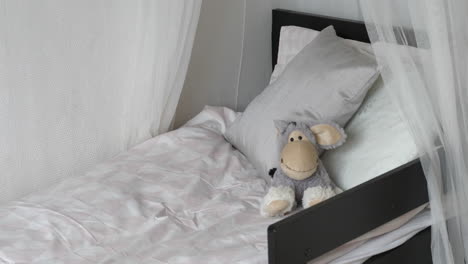 empty bed of child with soft toy, home interior design, motion view